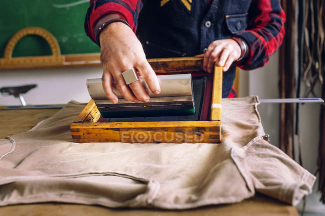 Worker using squeegee — Stock Photo