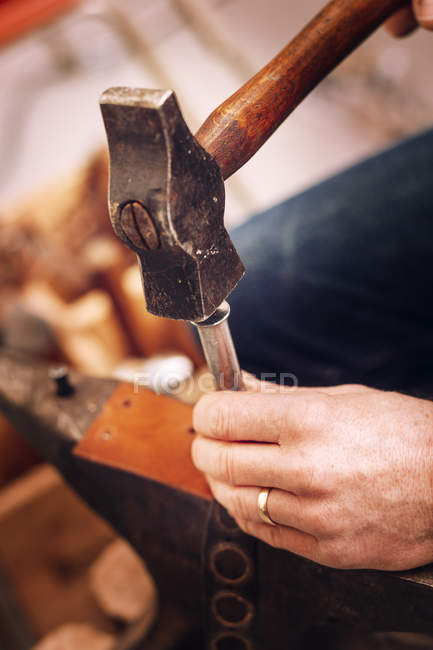 Worker making holes on belt — Stock Photo