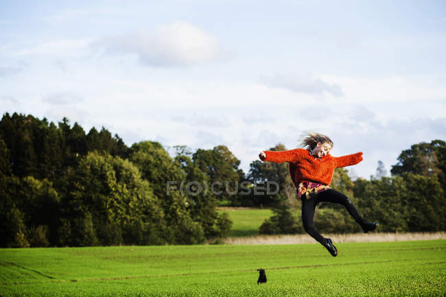 Happy young woman jumping — Stock Photo