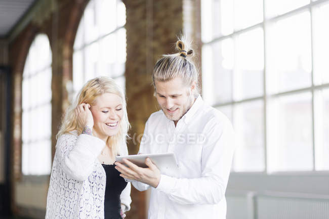 Man and woman using digital tablet — Stock Photo