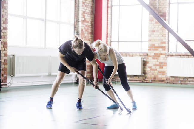 Man and woman playing hockey — Stock Photo