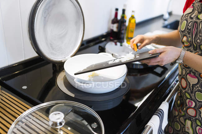 Woman cooking food in kitchen — Stock Photo
