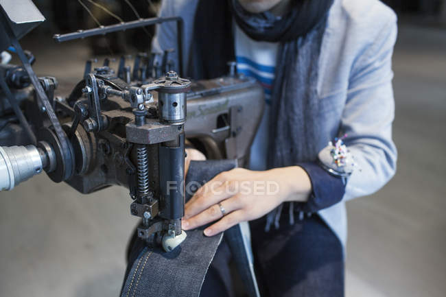 Fashion designer using sewing machine — Stock Photo