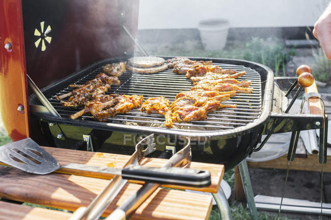 Meat chops grilling on barbeque — Stock Photo