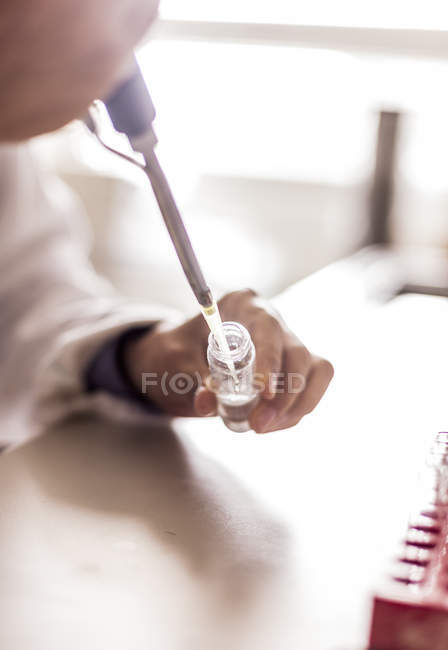 Researchers hand mixing solution — Stock Photo