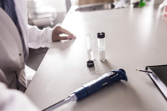 Doctor with medicine and pipette — Stock Photo