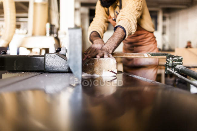 Carpenter using machine in workshop — Stock Photo