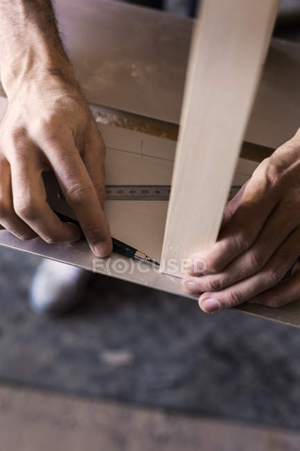 Carpenters hands marking on wood — Stock Photo