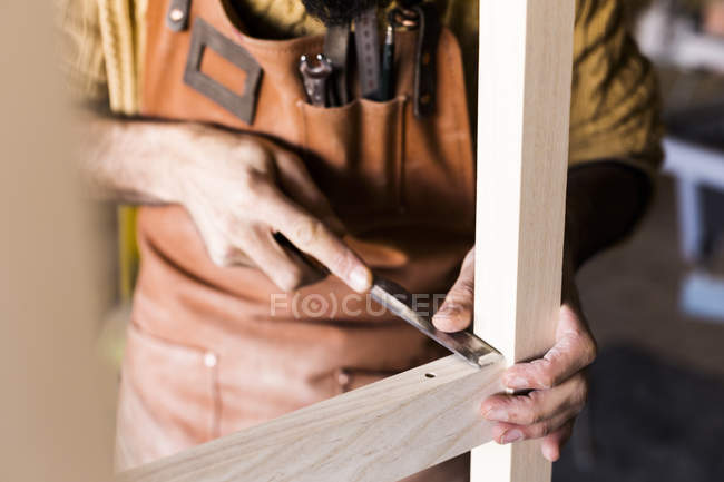 Carpinteros manos usando cincel en taller - foto de stock
