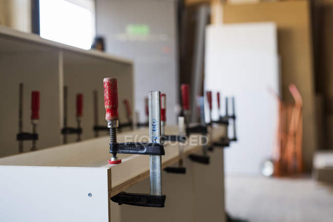 Clamps attached on plank — Stock Photo