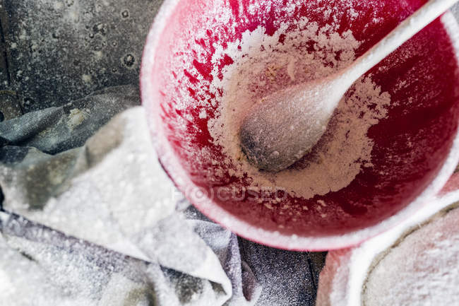 Flour and spoon in bowl — Stock Photo