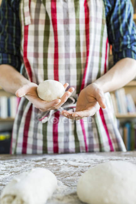 Baker kneading dough at table — Stock Photo