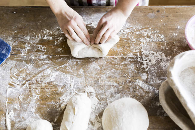 Bakers hands kneading dough — Stock Photo
