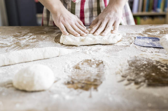 Bakers hands kneading dough — Stock Photo