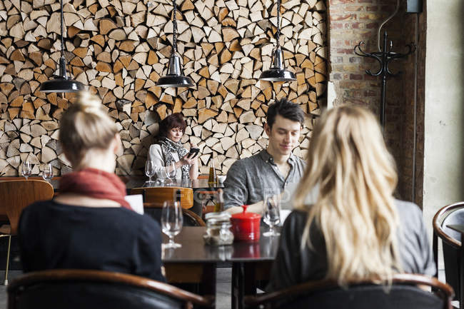 Man and women sitting in restaurant — Stock Photo
