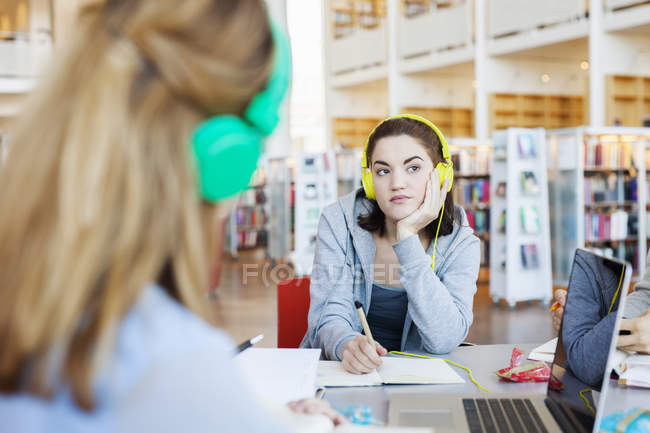 Young woman listening to lecture — Stock Photo