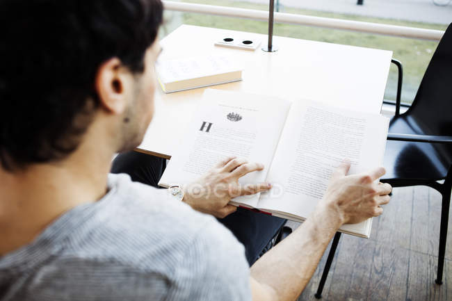 Young man reading book — Stock Photo