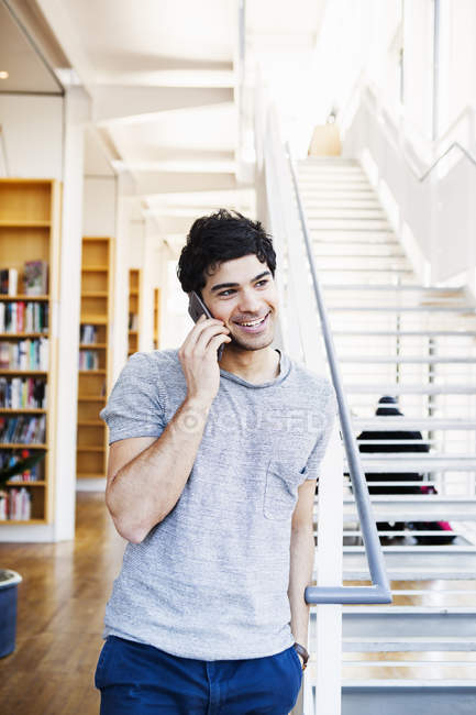 Happy man in library — Stock Photo