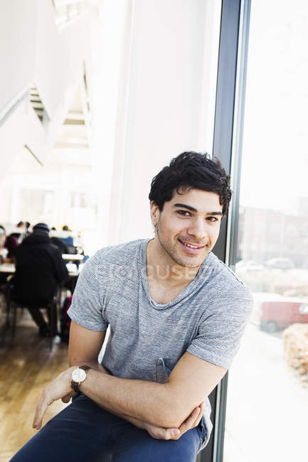 Happy man in library — Stock Photo