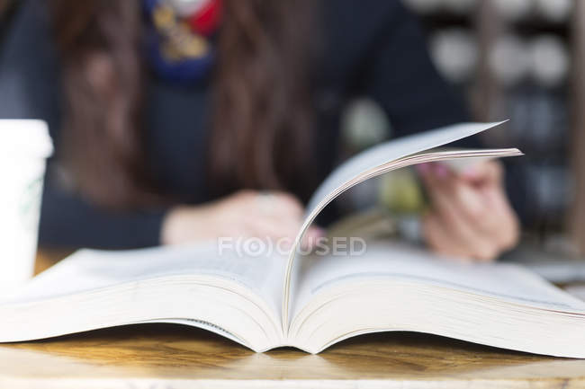 Woman turning pages — Stock Photo