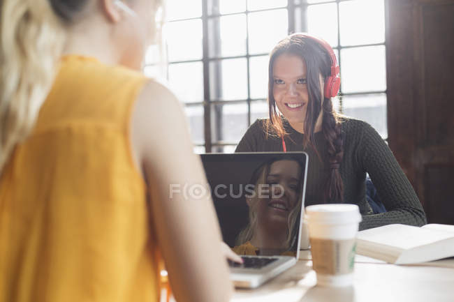 Smiling young woman wearing headphones — Stock Photo
