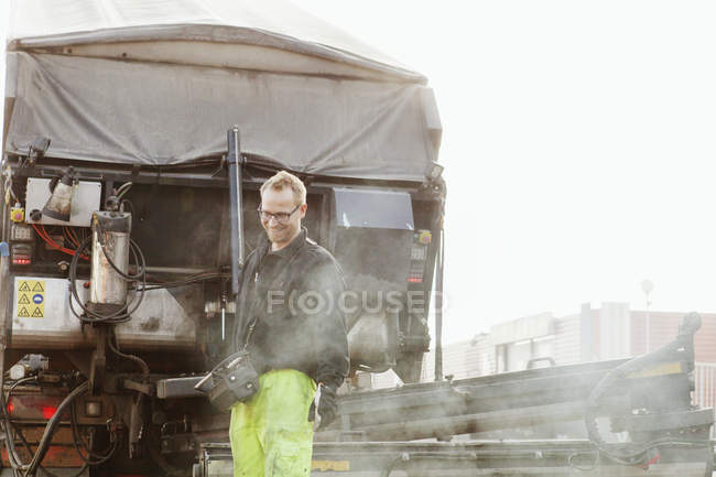 Smiling mature worker at road — Stock Photo