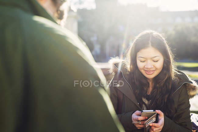 Teenage girl using smart phone — Stock Photo