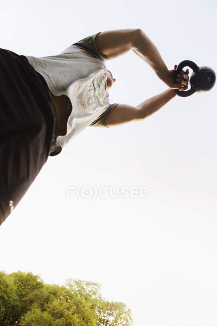 Young man exercising with kettlebell — Stock Photo