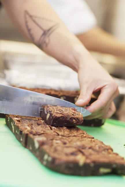 Chef cutting brownies — Stock Photo