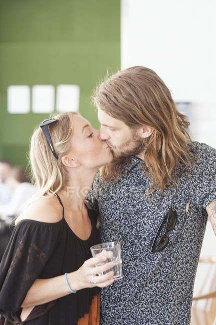 Jeune couple embrasser dans le restaurant — Photo de stock