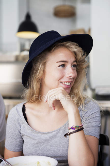 Young woman at restaurant — Stock Photo