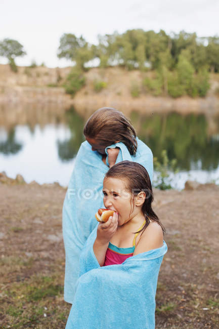 Wet girl wrapped in towel with sister — Stock Photo