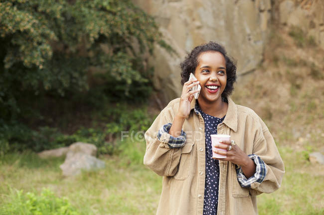 Woman holding disposable glass — Stock Photo