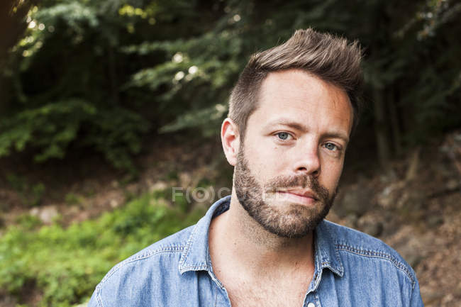 Portrait of confident man in forest — Stock Photo