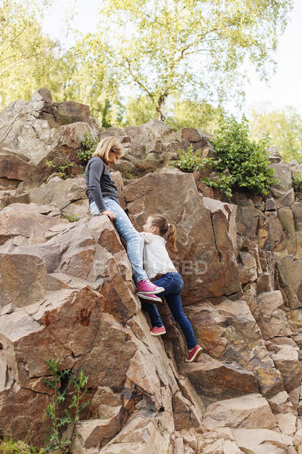 Sisters playing on rock — Stock Photo