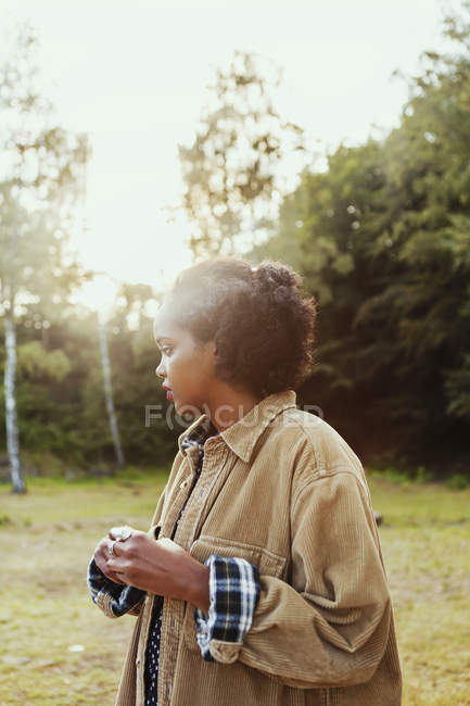 Young woman standing in forest — Stock Photo