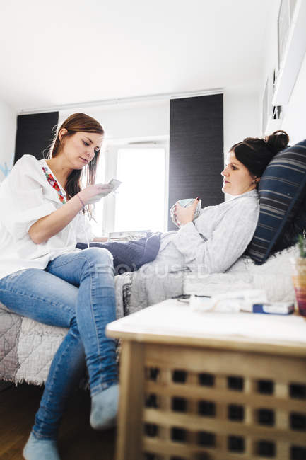 Woman reading blister pack — Stock Photo