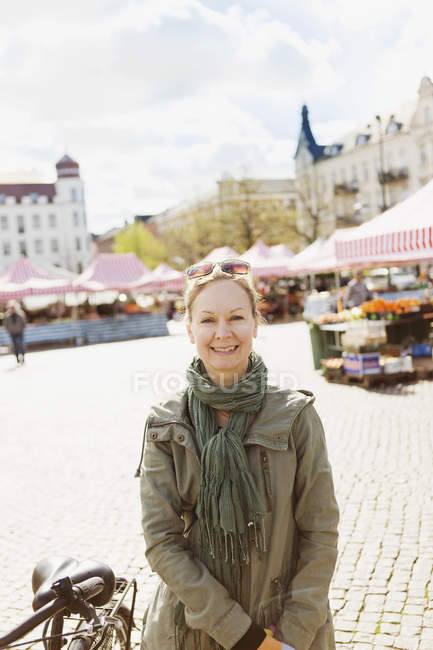 Happy mature woman in market — Stock Photo