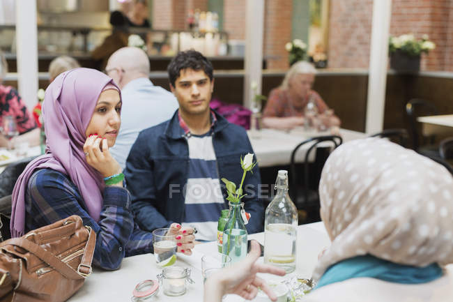Friends sitting at table — Stock Photo