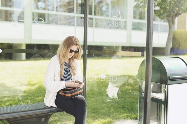 Young woman using phone — Stock Photo