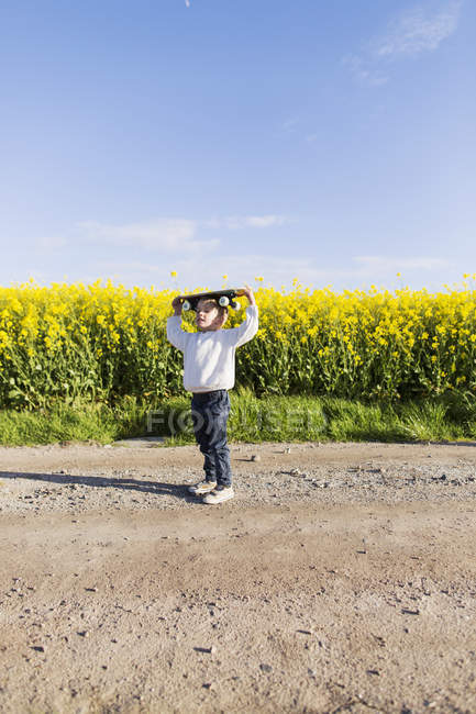 Boy carrying skateboard — Stock Photo