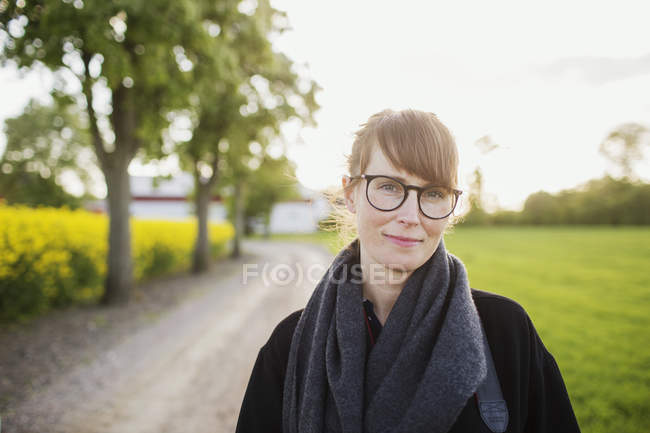 Confident woman standing at field — Stock Photo