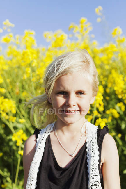 Menina feliz no campo de colza — Fotografia de Stock