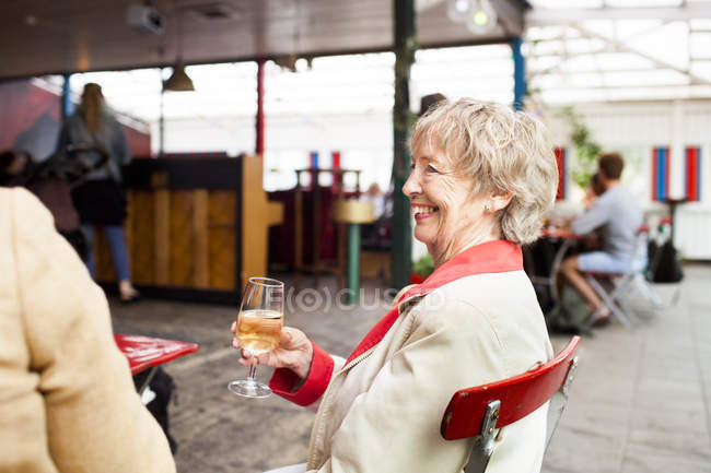 Senior woman holding wineglass — Stock Photo