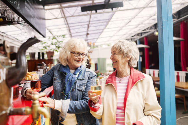 Senior women holding wineglasses — Stock Photo