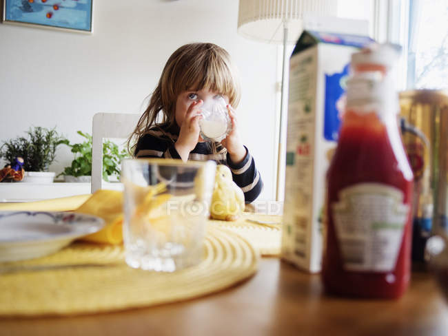 Little girl drinking milk — Stock Photo