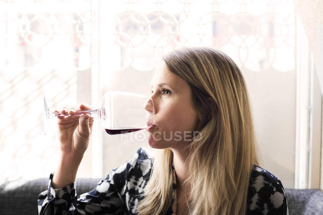 Woman drinking red wine — Stock Photo