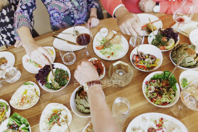 Friends having supper at table — Stock Photo