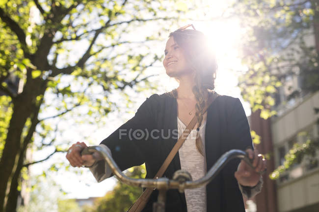 Happy young woman on bicycle — Stock Photo
