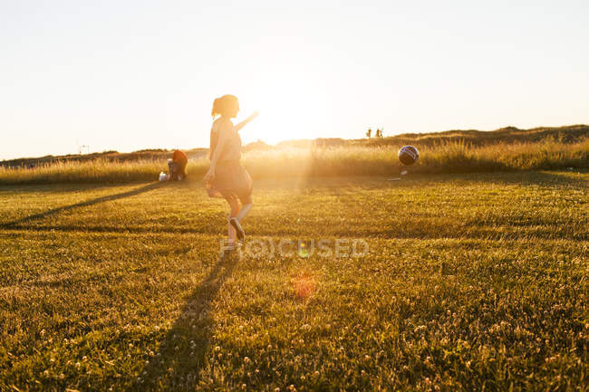 Young woman playing football — Stock Photo
